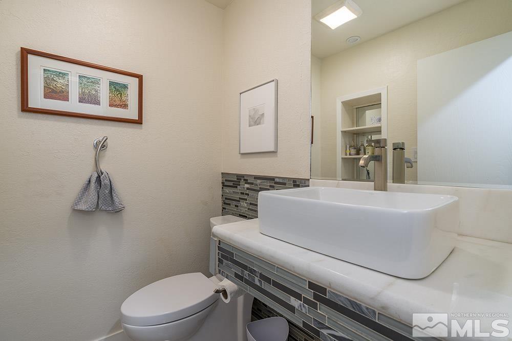 2012 Tremont Lane Reno, NV 89509 - Photo 16 of 20 a bathroom with a toilet a sink and mirror