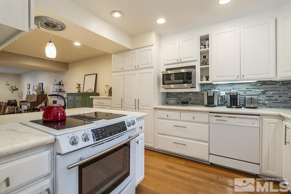 2012 Tremont Lane Reno, NV 89509 - Photo 9 of 20 a kitchen with stainless steel appliances granite countertop a stove a sink and a microwave