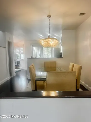 a view of dining room and kitchen with a sink