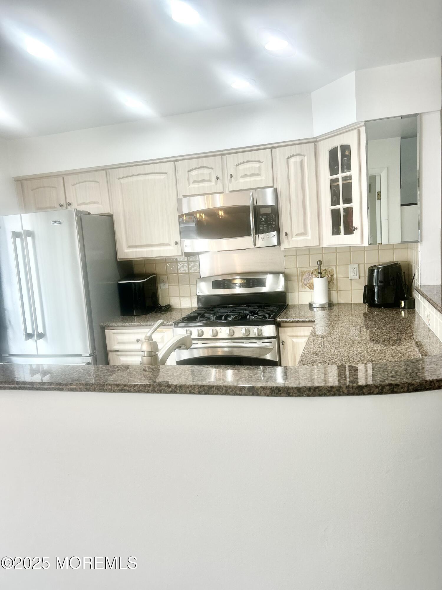 5 Sea Breeze Court Long Branch, NJ 07740 - Photo 14 of 28 a kitchen with stainless steel appliances granite countertop a sink and a granite counter tops