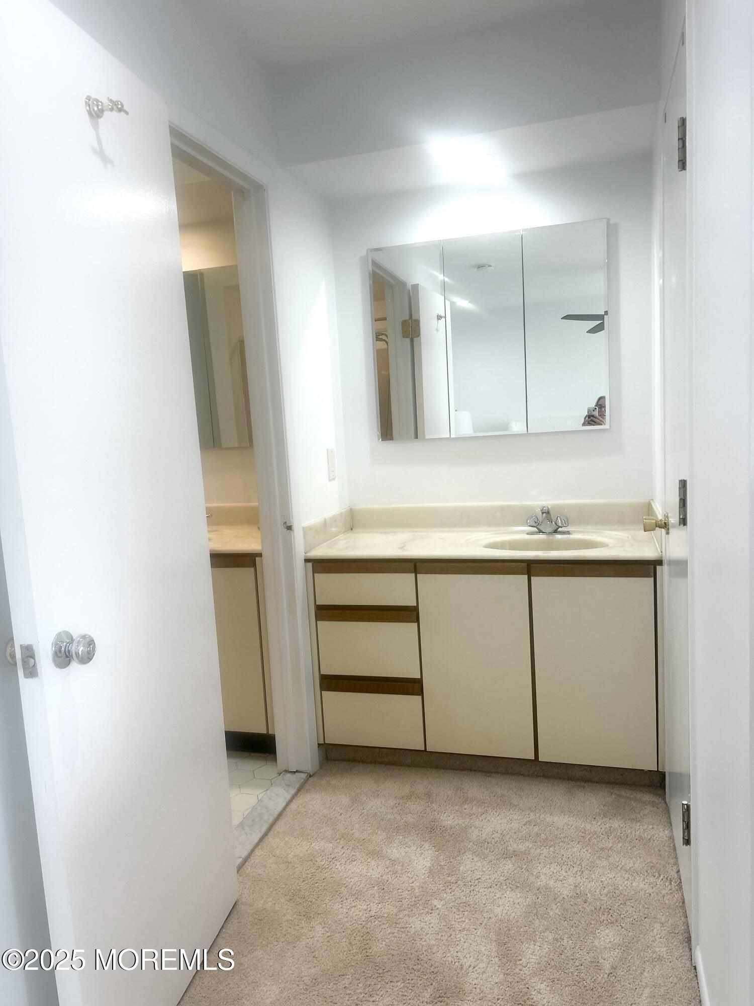 5 Sea Breeze Court Long Branch, NJ 07740 - Photo 21 of 28 a bathroom with a granite countertop sink and a mirror
