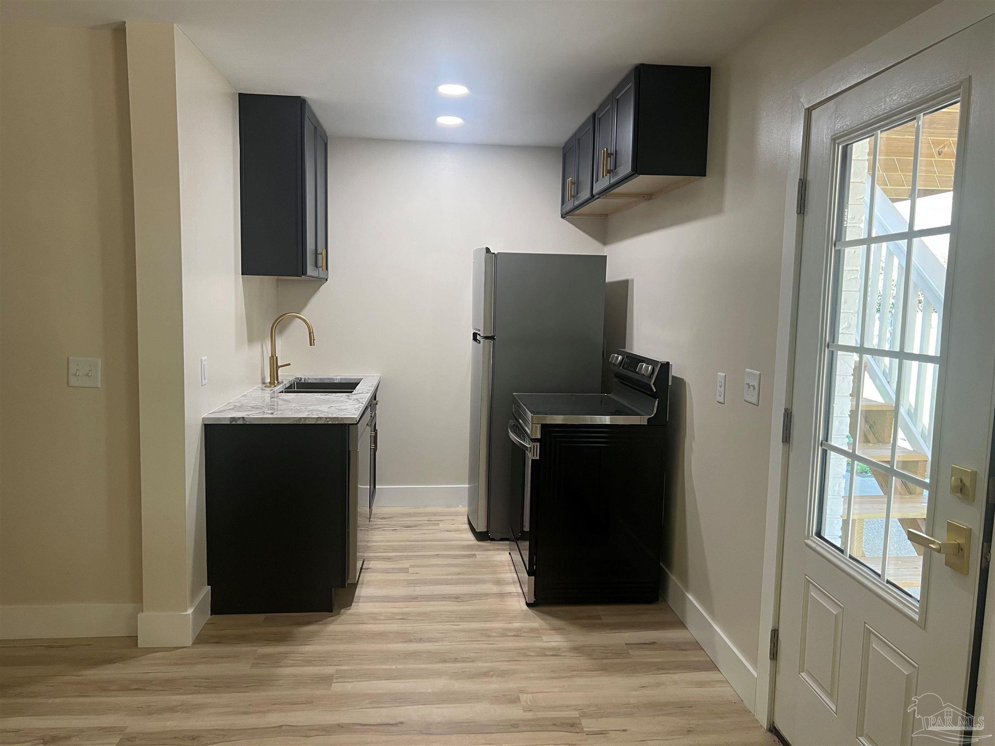 3111 Holley Point Road Navarre, FL 32566 - Photo 16 of 23 a kitchen with stainless steel appliances granite countertop a refrigerator and a microwave