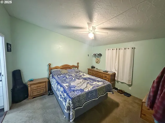 a bed sitting in a room next to a window