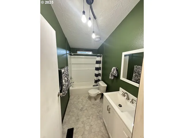 a bathroom with a toilet a sink and mirror
