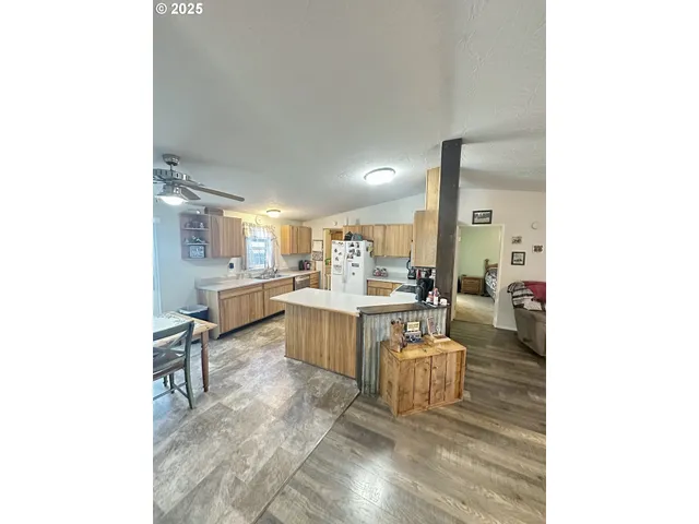 a living room with furniture and view of kitchen