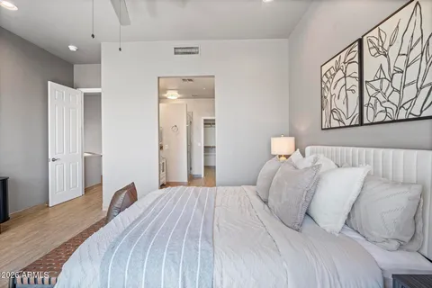 a bedroom with a large bed and a chandelier