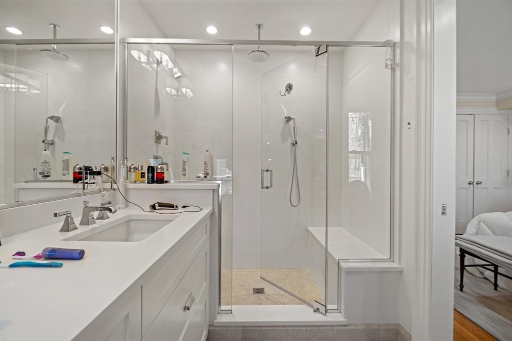 55 Dwight Street, Unit 1 Boston, MA 02118 - Photo 12 of 15 a bathroom with a shower sink vanity and mirror
