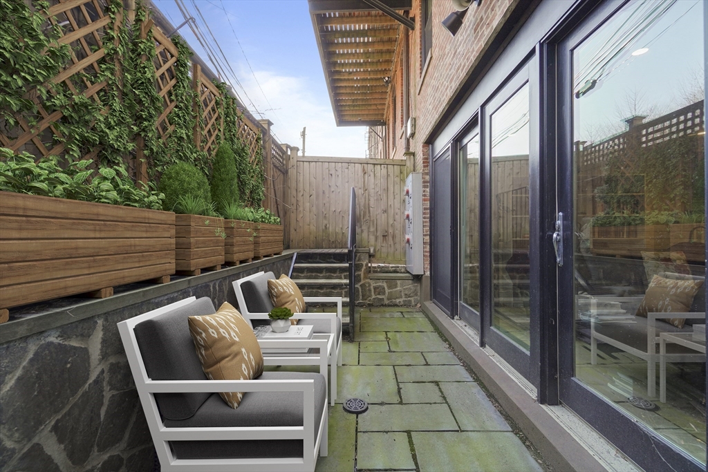 55 Dwight Street, Unit 1 Boston, MA 02118 - Photo 3 of 15 a view of balcony with a couch and wooden floor