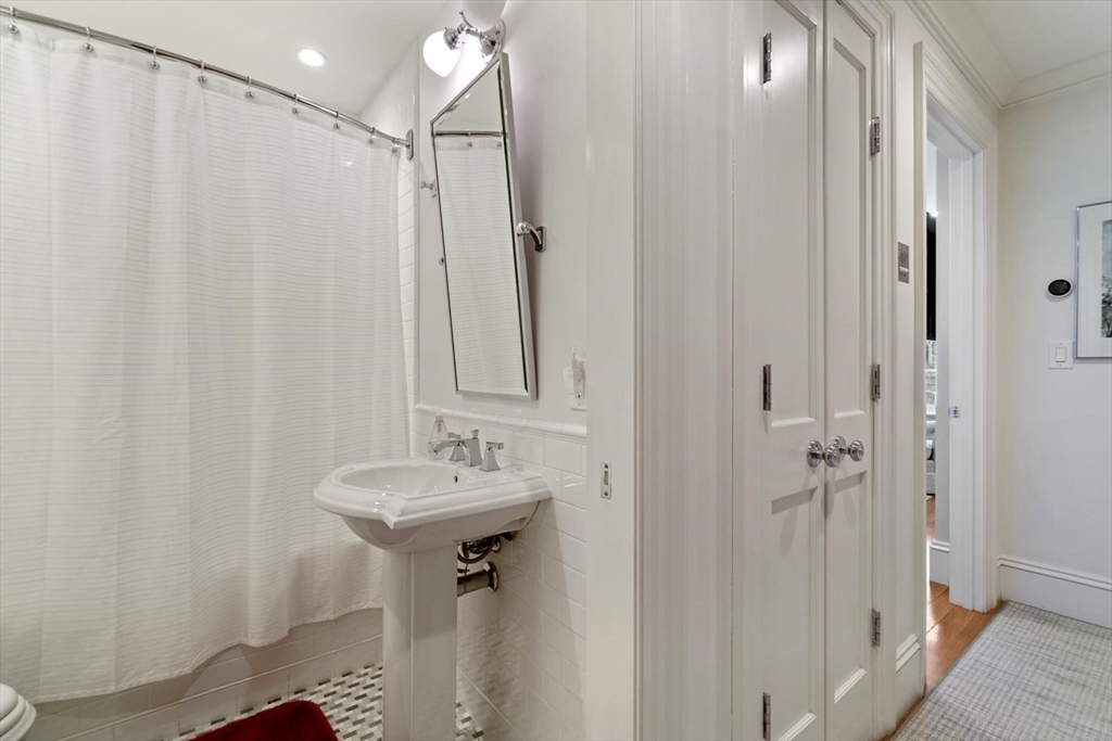 55 Dwight Street, Unit 1 Boston, MA 02118 - Photo 7 of 15 a bathroom with a sink a mirror and shower