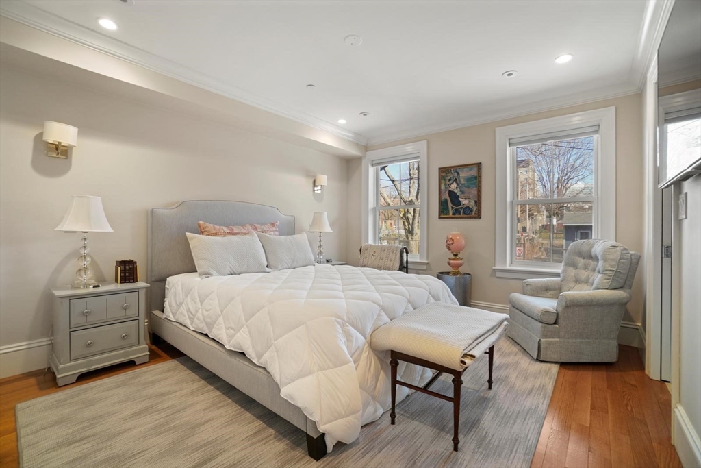 55 Dwight Street, Unit 1 Boston, MA 02118 - Photo 9 of 15 a spacious bedroom with a bed and a couch