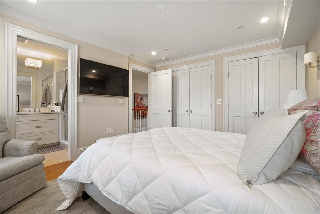 55 Dwight Street, Unit 1 Boston, MA 02118 - Photo 10 of 15 a spacious bedroom with a bed and a flat screen tv