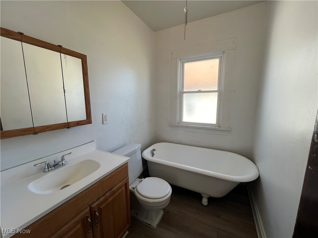 491 Cleveland Road Cleveland, OH 44108 - Photo 20 of 25 Bathroom featuring toilet, hardwood / wood-style floors, vanity, and a washtub