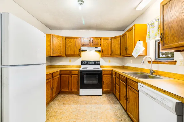 a kitchen with stainless steel appliances granite countertop a sink and a stove