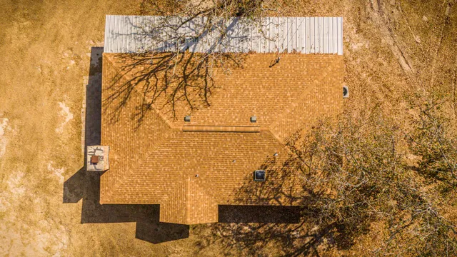 a house view with swimming pool in front of it