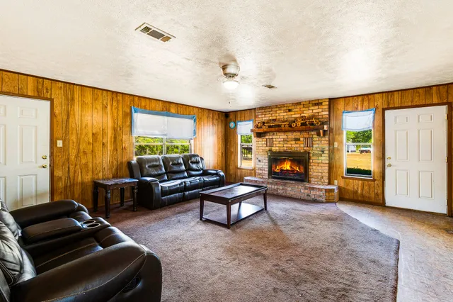 a living room with furniture and a fireplace