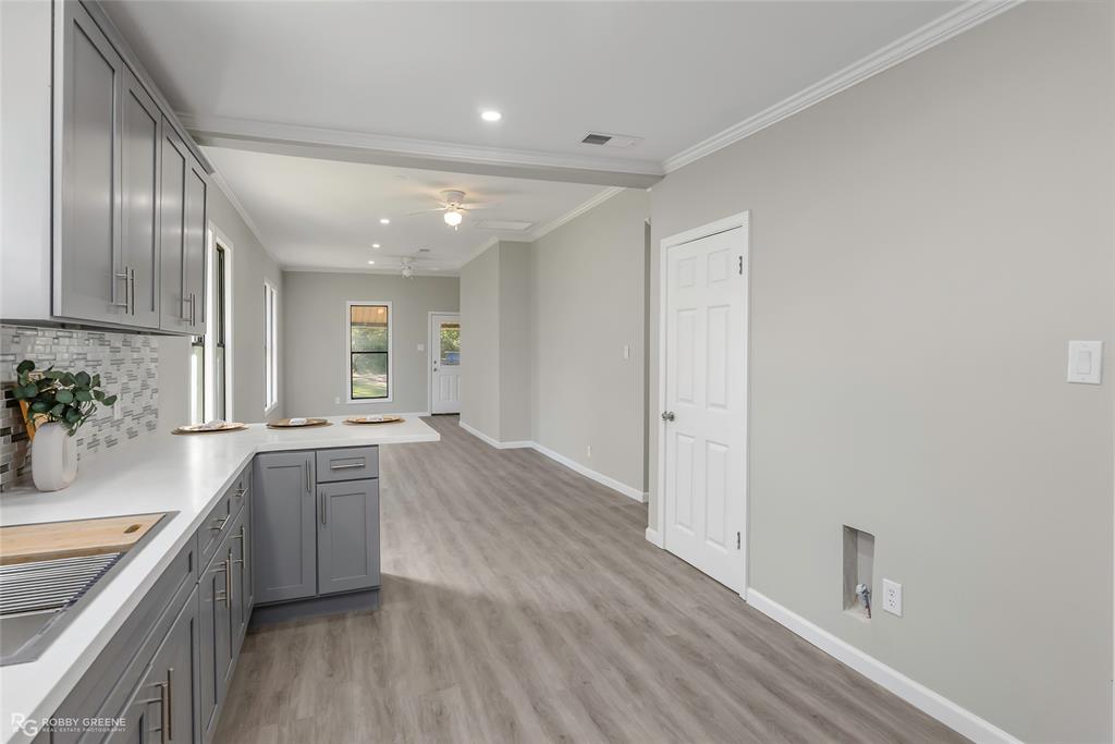 3112 Standard Oil Road Shreveport, LA 71108 - Photo 13 of 24 a large kitchen with stainless steel appliances granite countertop a lot of counter space and wooden floor
