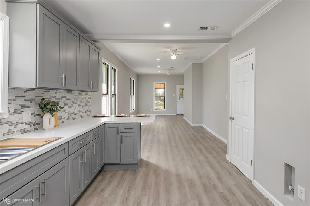 3112 Standard Oil Road Shreveport, LA 71108 - Photo 14 of 24 a large kitchen with stainless steel appliances granite countertop a lot of counter space and wooden floors
