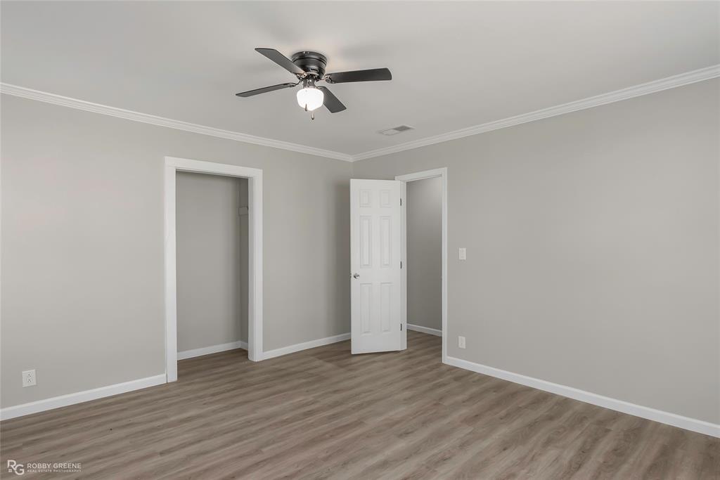 3112 Standard Oil Road Shreveport, LA 71108 - Photo 17 of 24 an empty room with wooden floor fan and windows