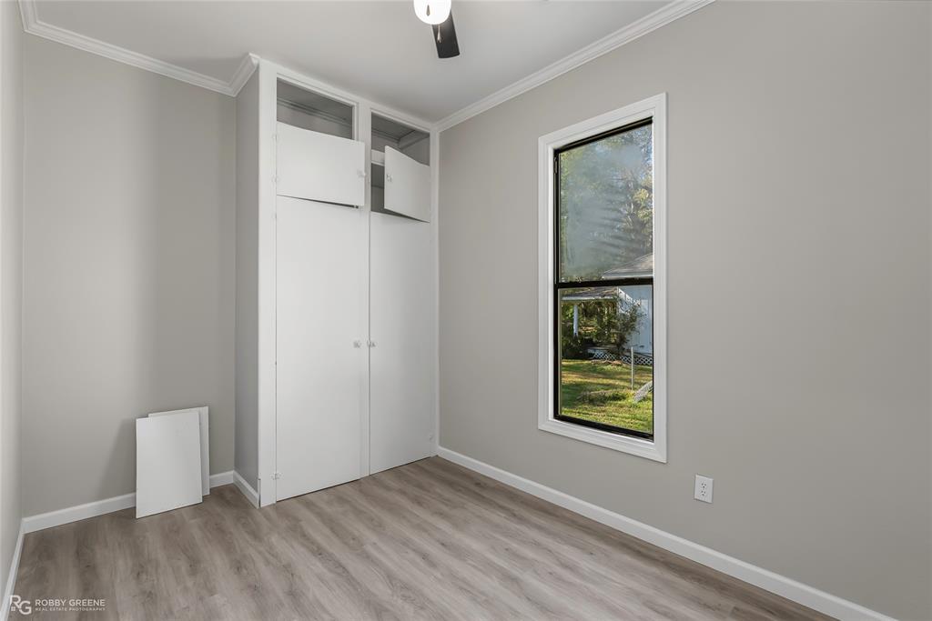 3112 Standard Oil Road Shreveport, LA 71108 - Photo 18 of 24 a view of an empty room with window and wooden floor