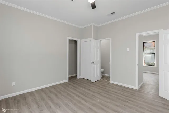 an empty room with windows and closet