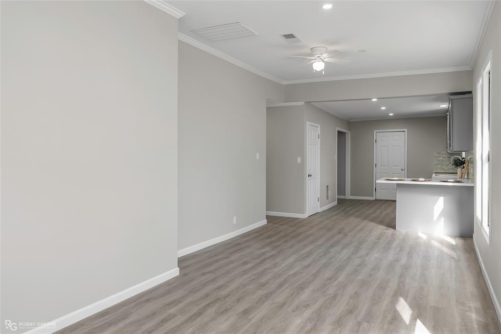 3112 Standard Oil Road Shreveport, LA 71108 - Photo 6 of 24 a view of a hallway with wooden floor and a kitchen