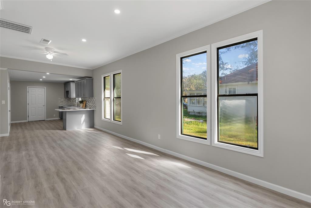 3112 Standard Oil Road Shreveport, LA 71108 - Photo 7 of 24 a view of an empty room with a window and wooden floor