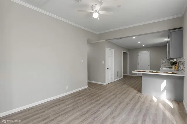 a kitchen with a sink cabinets and wooden floor