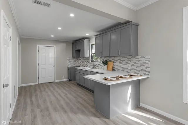 a kitchen with a sink cabinets and appliances