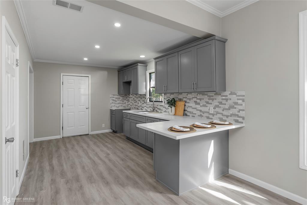 3112 Standard Oil Road Shreveport, LA 71108 - Photo 9 of 24 a kitchen with a sink cabinets and wooden floor