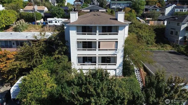 a view of a house with a yard and potted plants