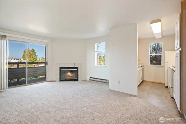an empty room with furniture and a kitchen