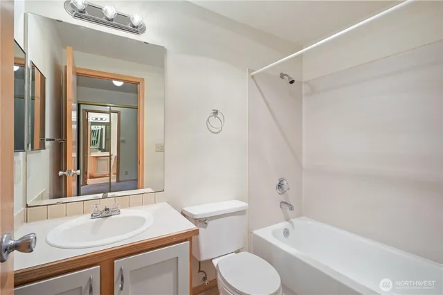 a bathroom with a sink toilet tub and shower