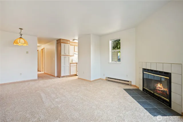 a view of empty room with a fireplace and fan