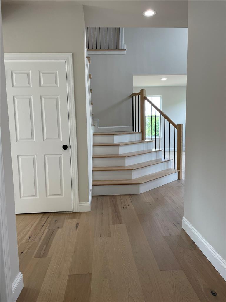 5043 Chapmans Road Orefield, PA 18069 - Photo 2 of 30 Natural wood flooring complements the staircase, creating a warm and welcoming entrance.