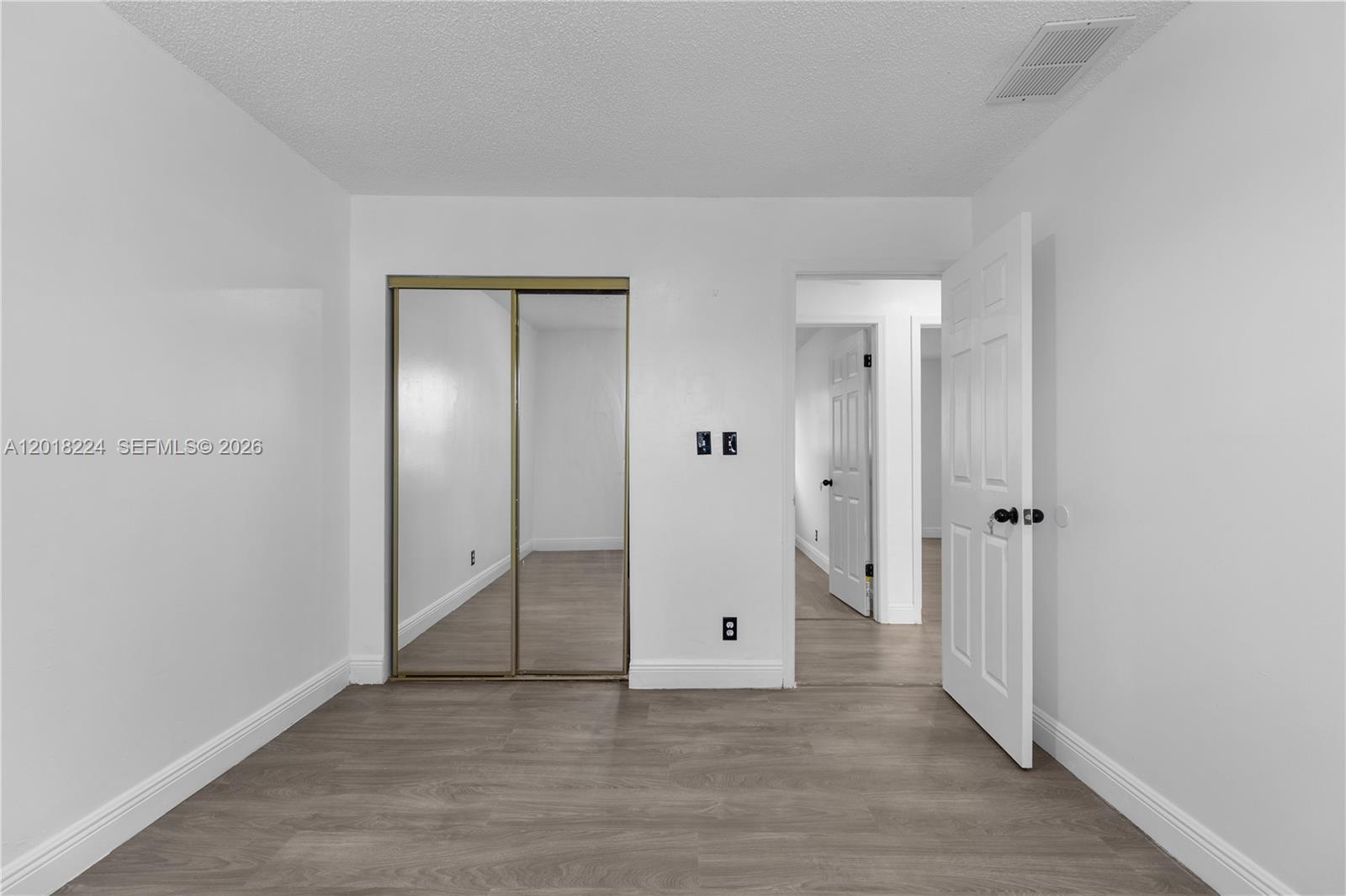 7958 Southwest 6th Street Pompano Beach, FL 33068 - Photo 26 of 57 an empty room with mirror