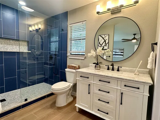 a bathroom with a toilet a sink and mirror