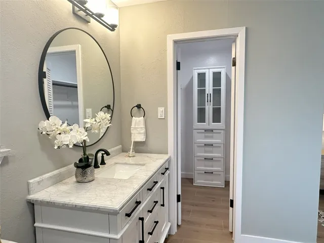 a bathroom with a sink vanity and a mirror