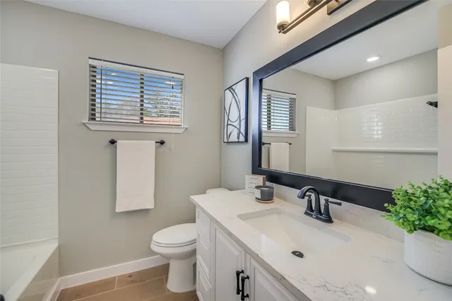 a bathroom with a sink a toilet and mirror