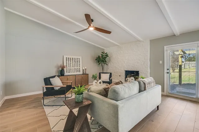 a living room with furniture and a floor to ceiling window