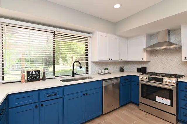 a kitchen with a sink stove and cabinets