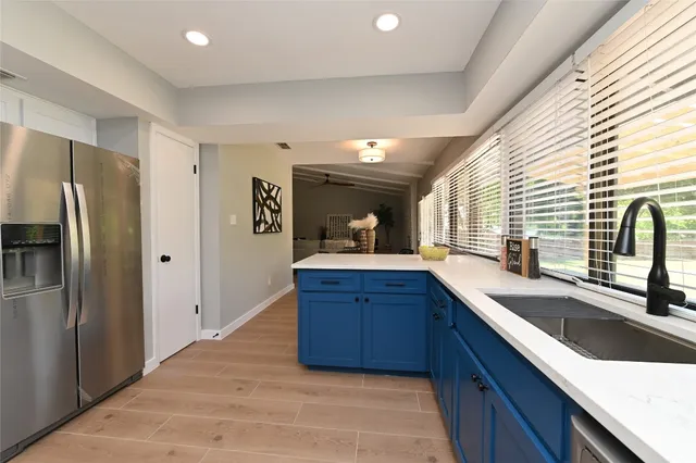 a kitchen with stainless steel appliances granite countertop a refrigerator and a sink