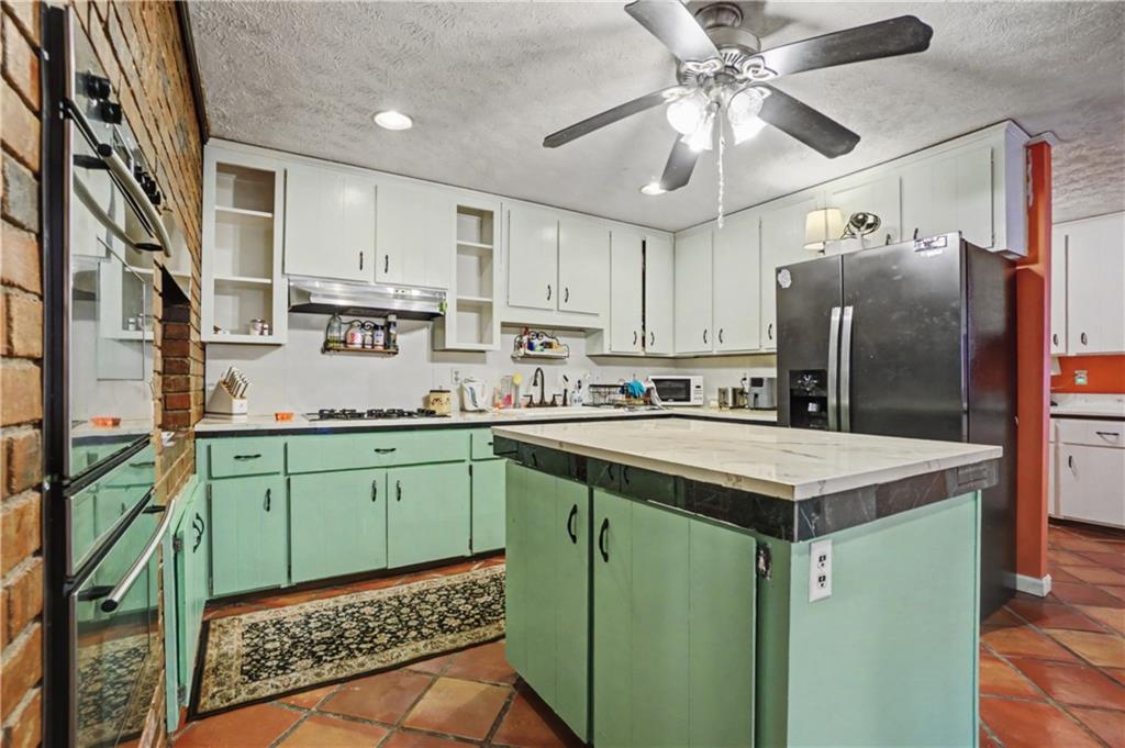 5075 Deen Road Marietta, GA 30066 - Photo 18 of 37 a kitchen with cabinets a sink and stainless steel appliances