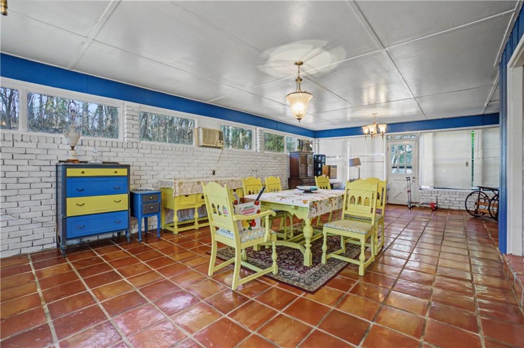 5075 Deen Road Marietta, GA 30066 - Photo 22 of 37 a view of a dining room with furniture a chandelier and kitchen view