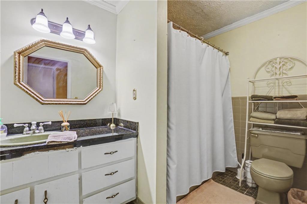 5075 Deen Road Marietta, GA 30066 - Photo 27 of 37 a bathroom with a granite countertop toilet sink and mirror