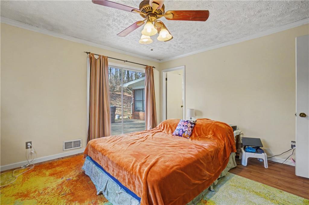 5075 Deen Road Marietta, GA 30066 - Photo 30 of 37 a bedroom with a bed and a chandelier