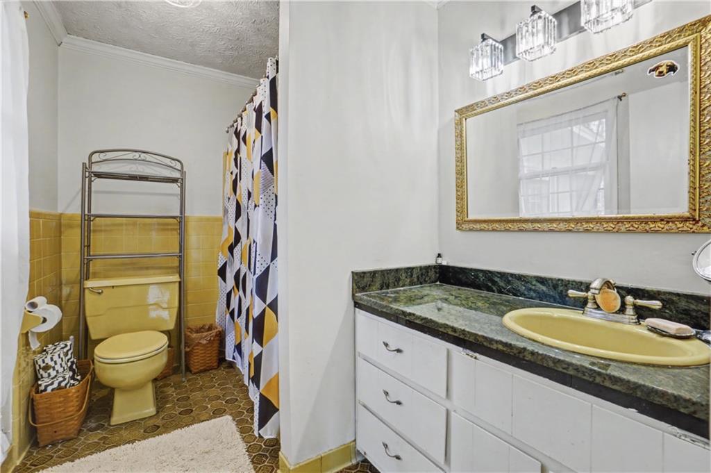 5075 Deen Road Marietta, GA 30066 - Photo 31 of 37 a bathroom with a granite countertop sink mirror vanity and toilet