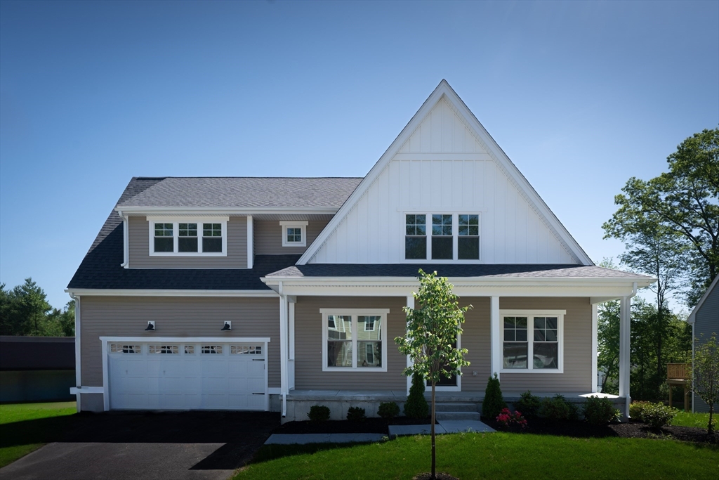 145 Mantell Road Uxbridge, MA 01569 - Photo 4 of 13 a front view of a house with a yard and garage