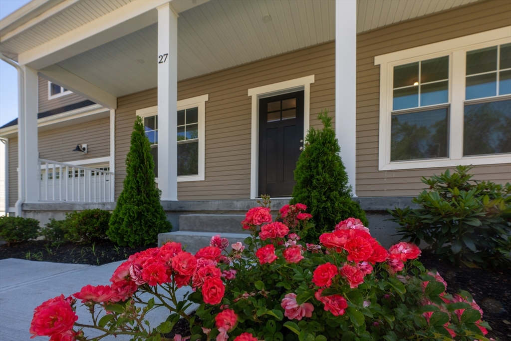 145 Mantell Road Uxbridge, MA 01569 - Photo 6 of 13 a view of a house that has a flower garden