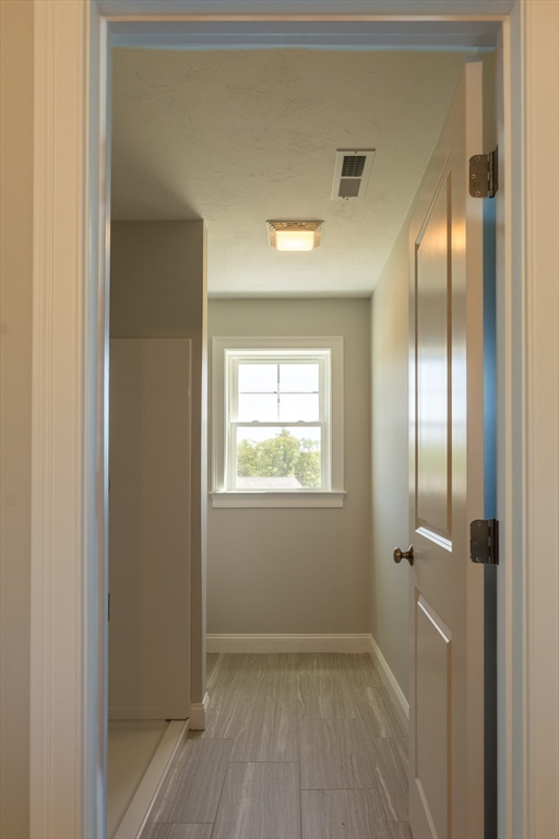 145 Mantell Road Uxbridge, MA 01569 - Photo 10 of 13 a view of an empty room with wooden floor and a window