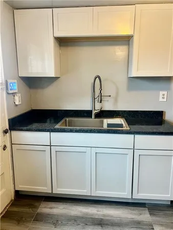 a close view of a stove a microwave and cabinets